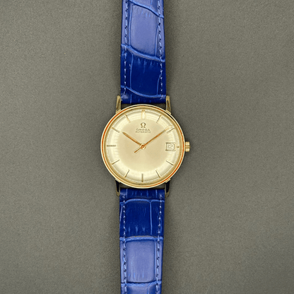 Gold plated vintage Omega watch with a blue strap 