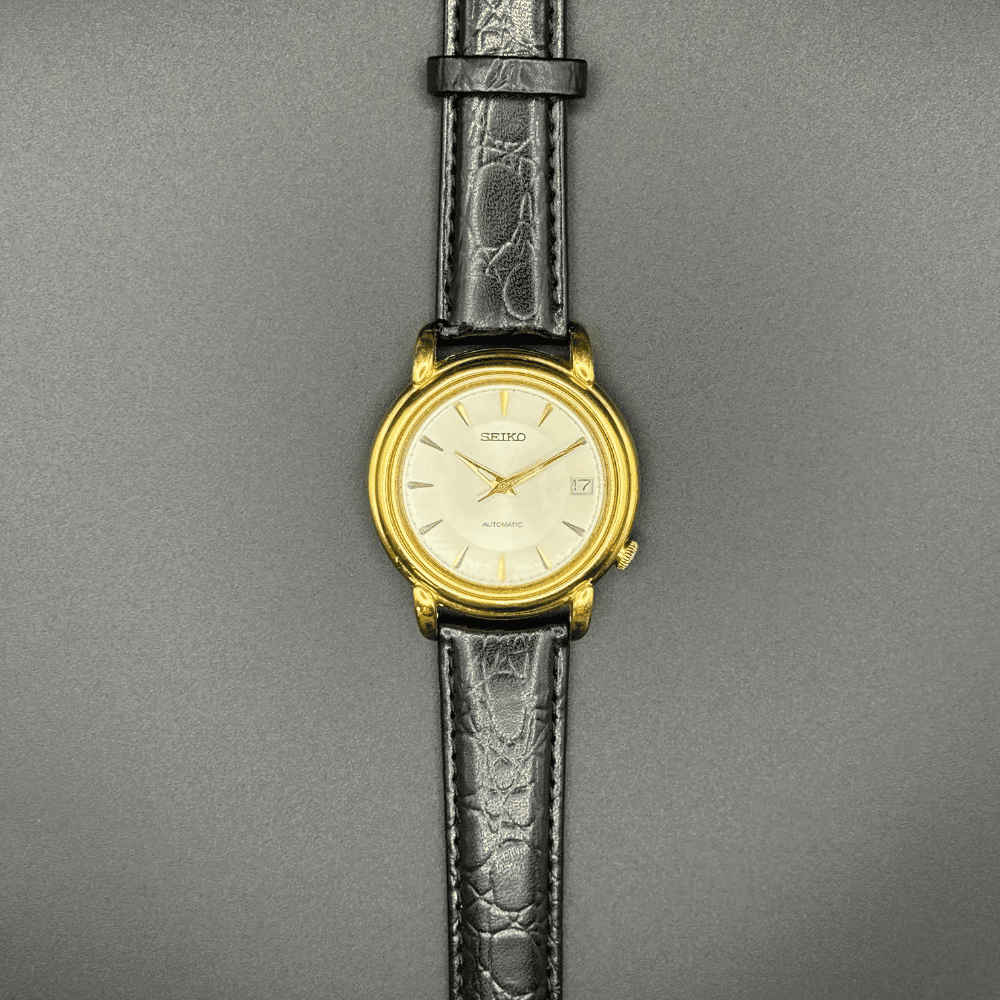 Seiko 7002-8010 Automatic, 1970s, Gold Tone champagne dial with black strap